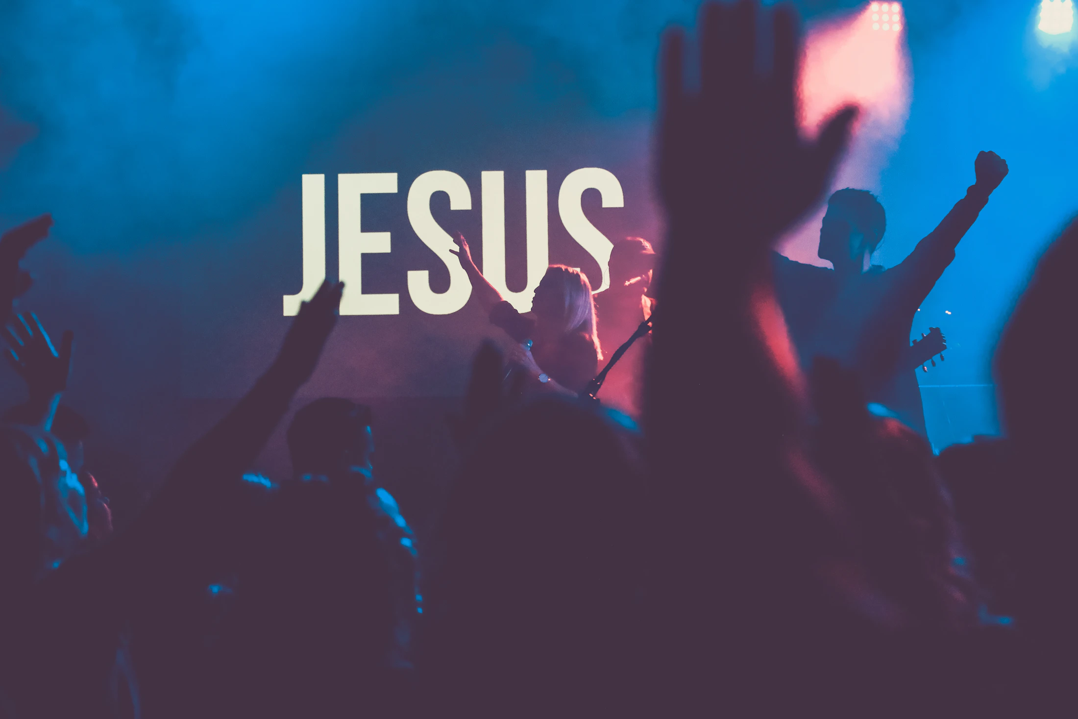 Hands lifted in worship — illustrative photography